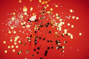Razor with heart shaped shaving foam. Bright red background with silver glitters and gold round confetti photo