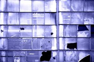 Broken windows of old industrial building photo