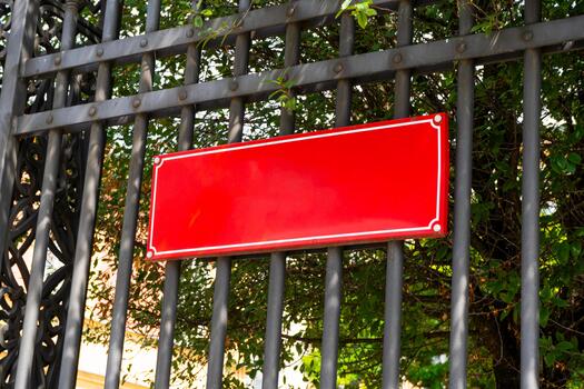 Red plate on the fence with space for text. Informant pointer. Signboard copy space photo