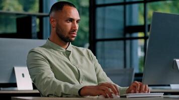 African American serious business man employer entrepreneur manager CEO typing keyboard computer in office work with net online project writing texting chatting using corporate app Internet service photo