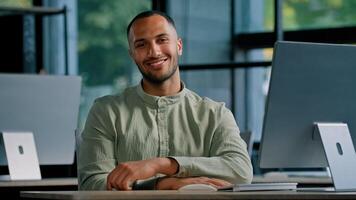 Happy smiling male investor multiracial worker developer programmer creative designer guy African American man with computer in office looking at camera smile sitting at table in company workplace photo