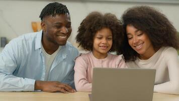 African American happy parents with little child call with laptop family hello biracial father mother with kid daughter girl online computer conference virtual conversation distant chat at home photo