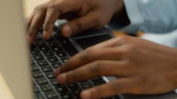 Unrecognizable biracial businessman student working studying with computer pc at table close up male African American user hands typing on laptop keyboard business worker study work online technology photo