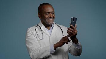 African American man male doctor in white uniform typing answer sending email message on smartphone browsing patient card using medical virtual application on mobile phone medicine and modern tech photo