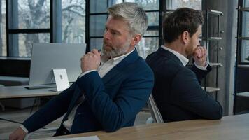 Two sad disappointed stressed worried caucasian businessmen men colleagues business partners entrepreneurs frustrated by bad news think about financial problem failure in office failed business deal photo