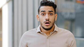 Portrait of young shocked surprised man close up scared frightened guy feeling shock surprise amazed from unexpected problems of bad news opens mouth wide emotional boss leader looking at camera photo