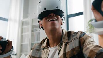 African American guy play virtual reality 3d cyber game ethnic funny amazed wonder man playing gaming wearing VR glasses helmet using joysticks future modern technology having fun at home metaverse photo