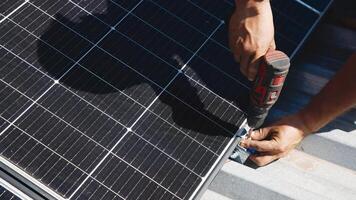 Connection and installation of solar panels. Workers attach solar panels. Technicians install solar panels on a metal stand. Workers install photovoltaic solar panels on the roof of a house photo