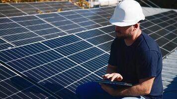A chief engineer oversees the installation of solar panels on a rooftop. The scene highlights expert supervision and modern renewable energy solutions in action photo
