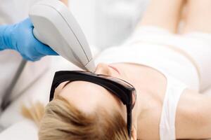 Laser hair removal procedure in an aesthetic clinic, focusing on facial hair removal from a female patient. Highlights advanced technology in hair removal and personalized skincare photo