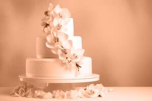 A beautiful peach-colored birthday cake on a background with a place to copy. photo