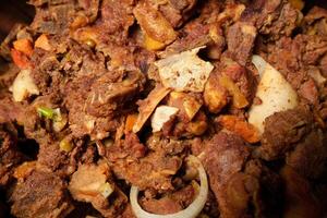 a close up of a bowl of meat and onions photo