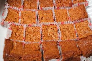 a tray of brownies with red and white paper photo