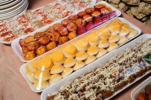 a table with many trays of food on it photo