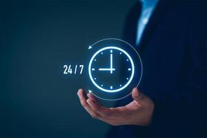 nonstop service concept. businessman show virtual 24-7 with clock for worldwide nonstop and full-time available contact of customer service concept. digital online customer service on internet network photo