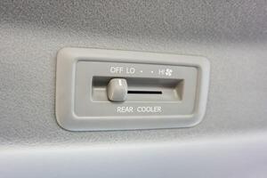 Car AC switches in the second row of the car. Air conditioner vent in the car ceiling. Vehicle AC controller photo