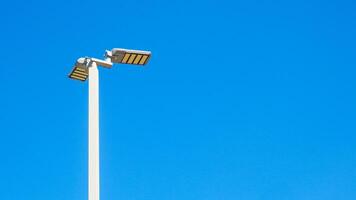 Modern Solar-Powered Street Light Against Clear Blue Sky on a Sunny Day photo