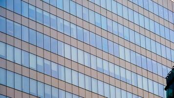 Modern Office Building with Glass Windows Reflecting the Sky in an Urban Setting photo