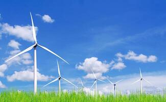 Wind Turbines in a Green Field Under a Blue Sky with White Clouds on a Sunny Day photo