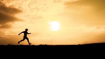 Silhouette of a Runner at Sunset with Golden Sky and Sun in the Background, Capturing the Essence of Outdoor Fitness and Nature photo