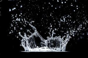 High-Speed Capture of Water Splash Against Black Background with Droplets in Mid-Air photo