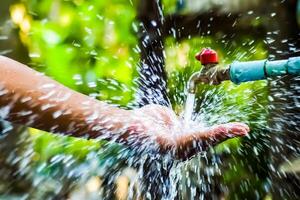 Refreshing Splash of Water from Outdoor Faucet in Lush Green Garden on a Sunny Day photo