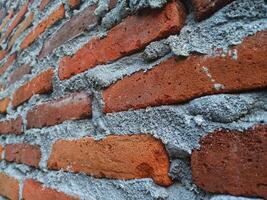 a close up of a brick wall with cement photo