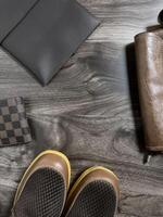 Leather bag with gadgets and notebooks on Wooden Work Desk photo