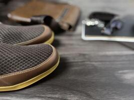 Leather bag with gadgets and notebooks on Wooden Work Desk photo