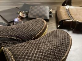 Leather bag with gadgets and notebooks on Wooden Work Desk photo