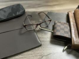 Leather bag with gadgets and notebooks on Wooden Work Desk photo