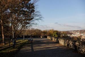 Walkway with benches and a view of the town in Vysehrad in Prague photo