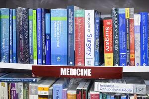New Delhi, India, July 17 2024 - Variety of Books on shelf inside a book-stall at Delhi International Book Fair, Selection of books on display in Annual Book Fair at Bharat Mandapam complex photo