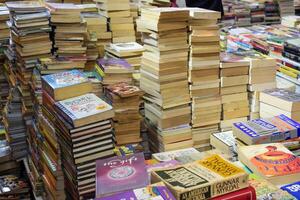 New Delhi, India, July 17 2024 - Variety of Books on shelf inside a book-stall at Delhi International Book Fair, Selection of books on display in Annual Book Fair at Bharat Mandapam complex photo