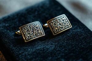 Elegant cufflinks resting on a plush surface photo