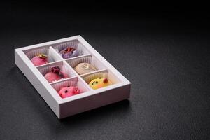 Delicious cold Japanese mochi dessert with colorful rice dough shell and fruit filling photo