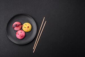 Delicious cold Japanese mochi dessert with colorful rice dough shell and fruit filling photo