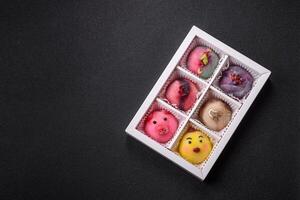 Delicious cold Japanese mochi dessert with colorful rice dough shell and fruit filling photo