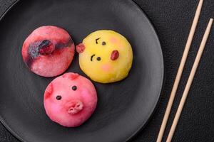 Delicious cold Japanese mochi dessert with colorful rice dough shell and fruit filling photo