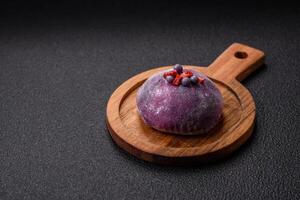 Delicious cold Japanese mochi dessert with colorful rice dough shell and fruit filling photo