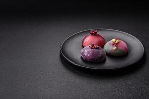 Delicious cold Japanese mochi dessert with colorful rice dough shell and fruit filling photo