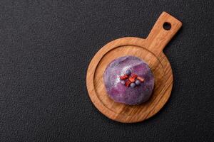 Delicious cold Japanese mochi dessert with colorful rice dough shell and fruit filling photo