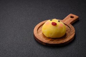 Delicious cold Japanese mochi dessert with colorful rice dough shell and fruit filling photo