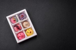 Delicious cold Japanese mochi dessert with colorful rice dough shell and fruit filling photo