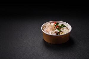 Delicious fresh caesar salad in a bowl with chicken breast, egg, tomatoes photo