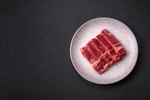 Fresh raw beef cut into slices with salt, spices photo