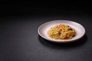 Delicious fresh pilaf with rice, carrots, meat, onions, spices and berries photo