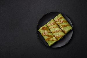 Spinach Crepes stuffed with chicken, mushrooms, salt and spices photo