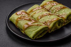 Spinach Crepes stuffed with chicken, mushrooms, salt and spices photo