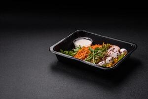 Fresh juicy salad with meat, mozzarella, carrots, lettuce, corn photo
